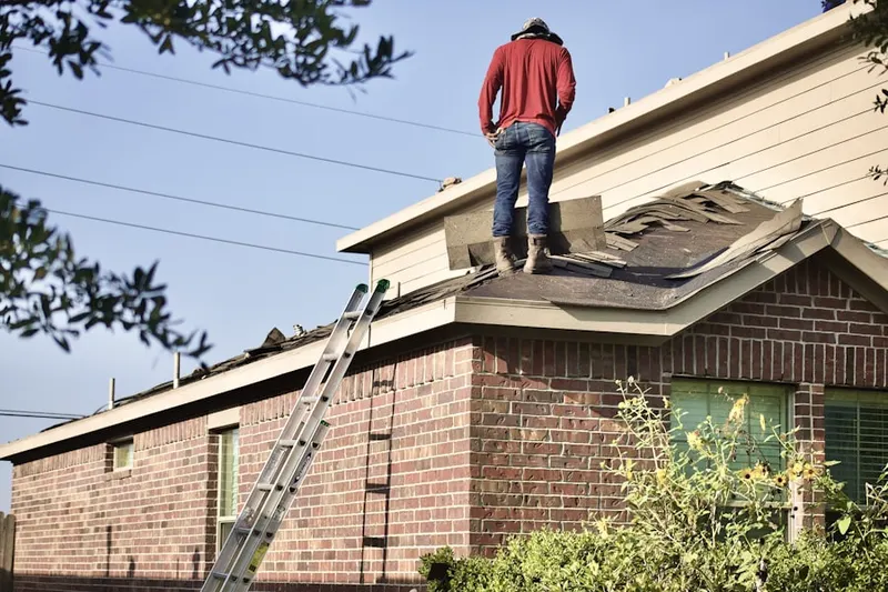 Professional roofer working on a residential roof in Hoboken